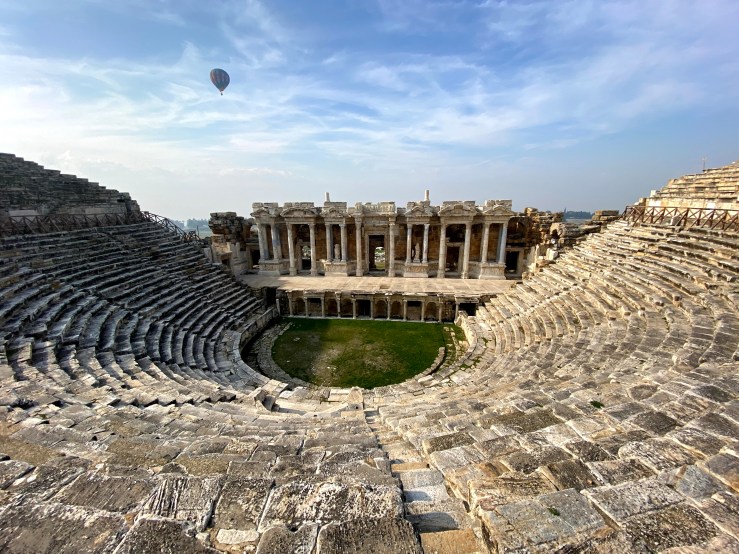 Roman amphitheatr, there is worn stone with huge columns with elaborate statues. This is the ancient city at Pamukkale