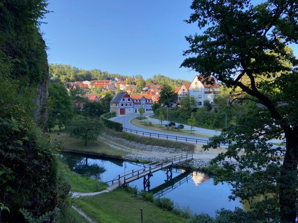 Traditional old German houses with a bridge across a slow river