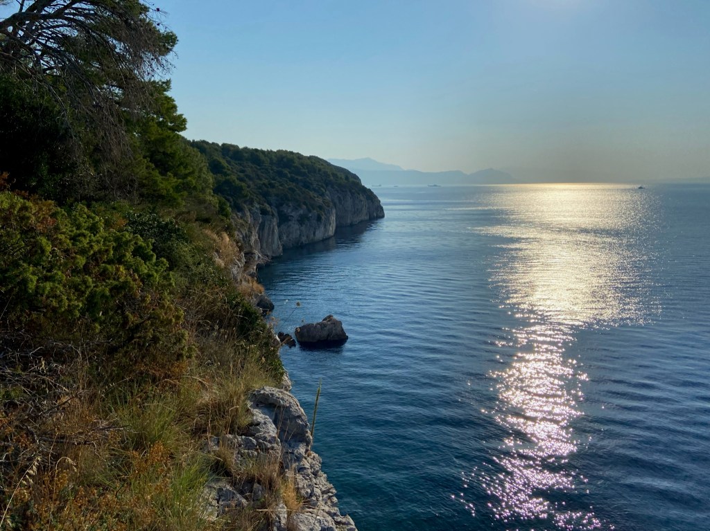 Cliff appearing from the blue sea.