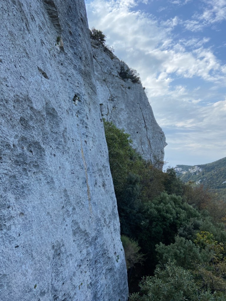 A white limestone crag with small pockets