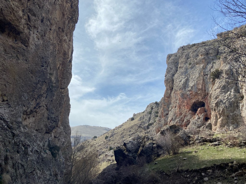 Rocky canyon opening out to grassy hills