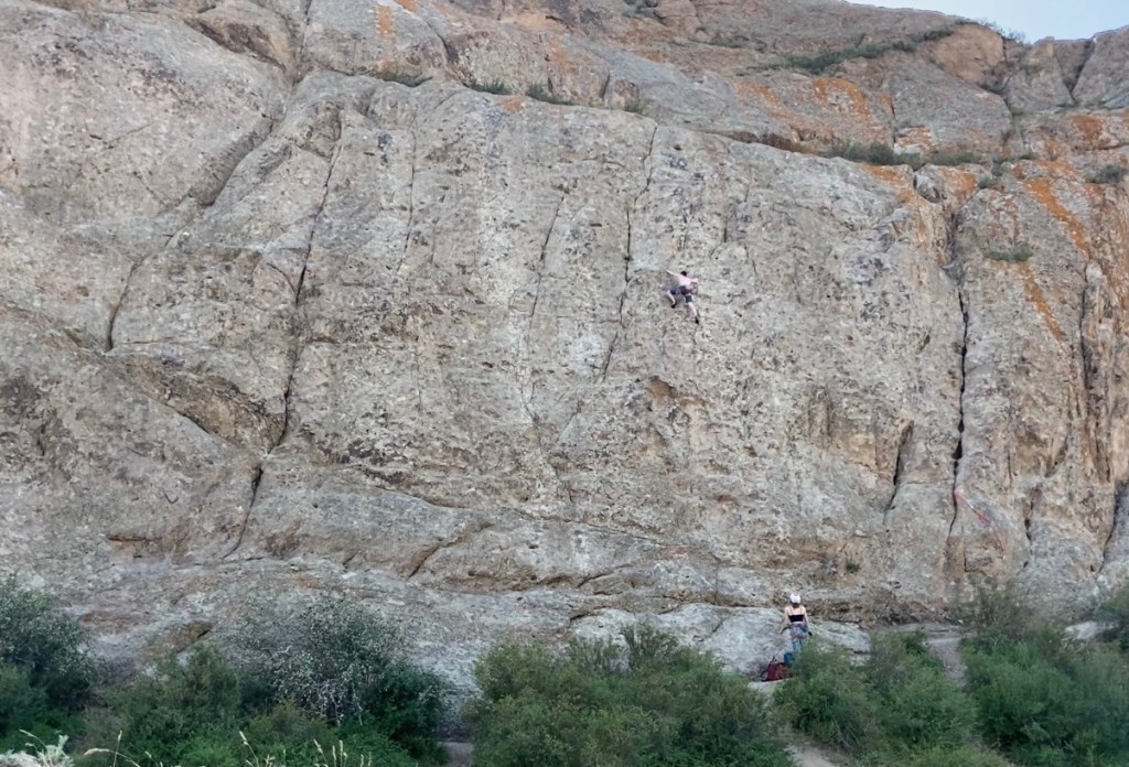 Climber on a route in the middle of the featured wall