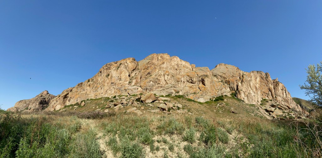Limestone lie cliff of Tamgaly-Tas it is sat upon a grassy bank