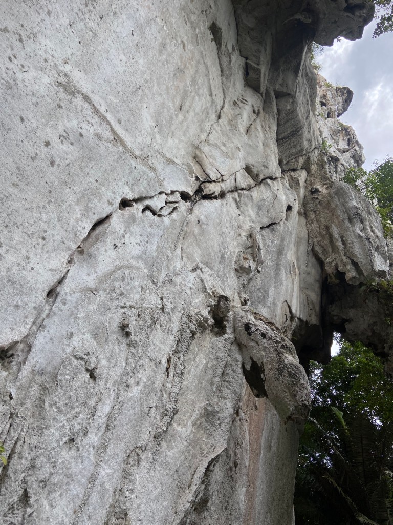 Pure white limestone cliff which massive dripping tufas and a distinct crack splitting the wall apart