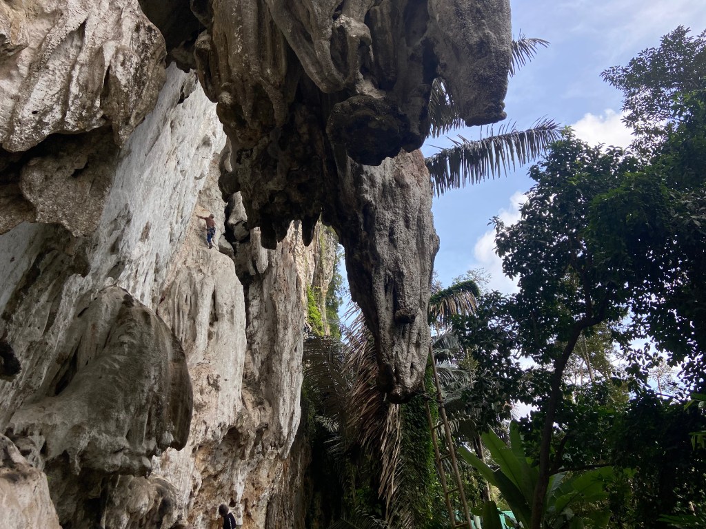 Massive tufas protruding from the crag at North Wall. Looking behind a tufa you can see a climber on the wall 