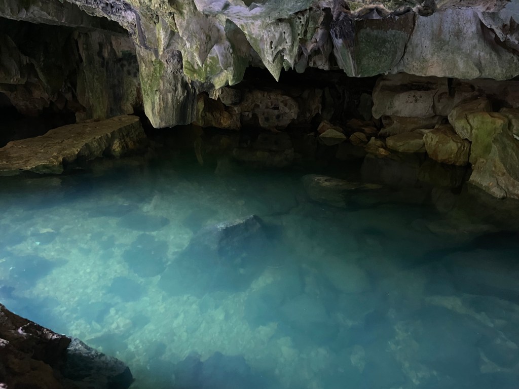 Clear spring in a small and narrow limestone cave