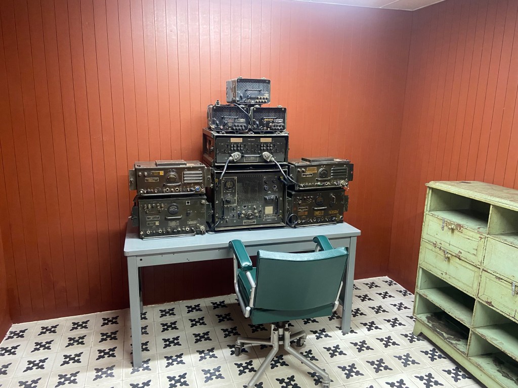 Old equipment and old furniture from the Vietnam War era in a wooden clad room in the bunker of the reunification palace in Ho Cho Minh City.
