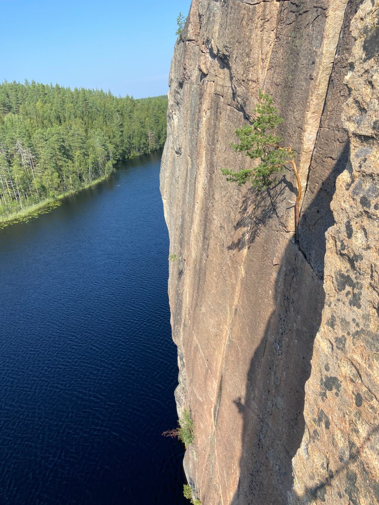 Shadow of a climber and the arete of one climb on the face of sector Laatta