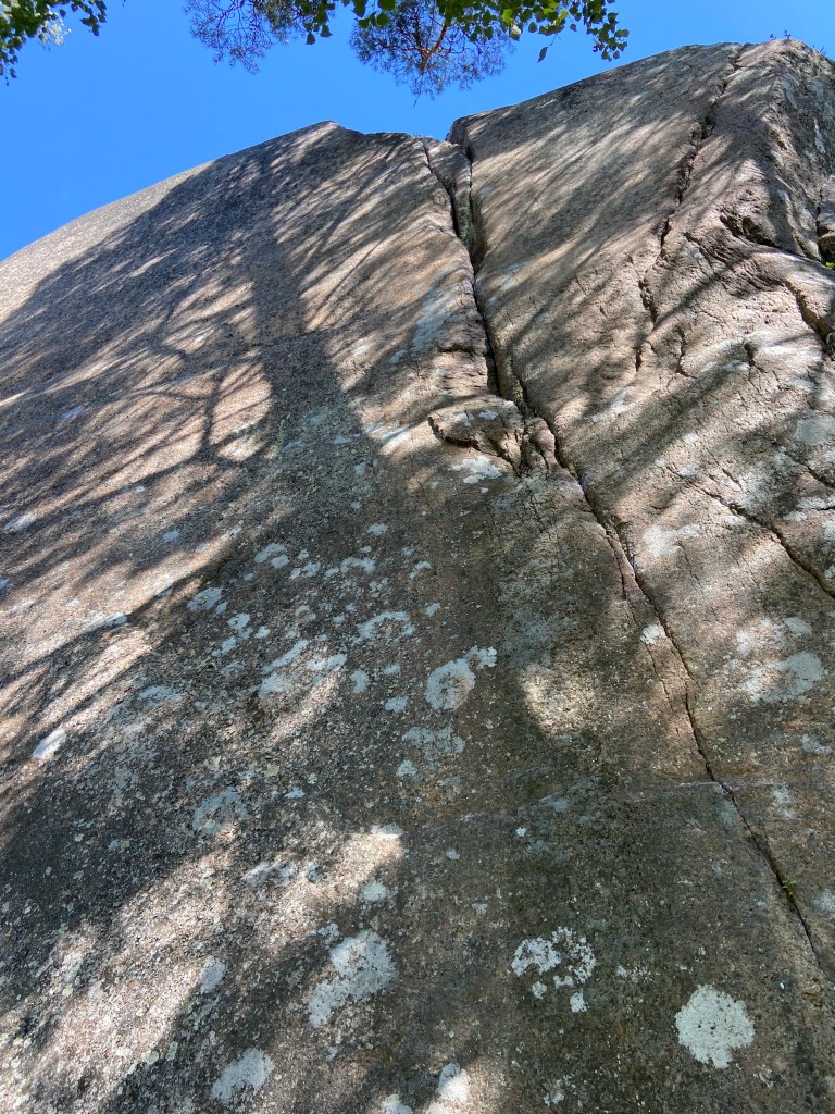 Granite outcrop with a prominent crack feature running to the top of the crag