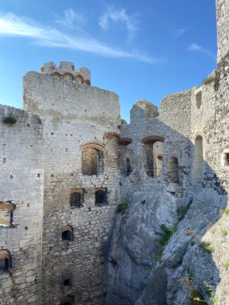 Historic stone walls encompassing the crag walls with windows in