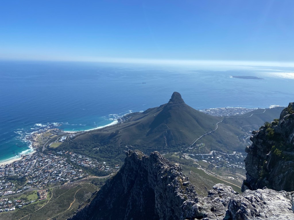 A view of the pointed mountain of lion's head with the sea and city below. 