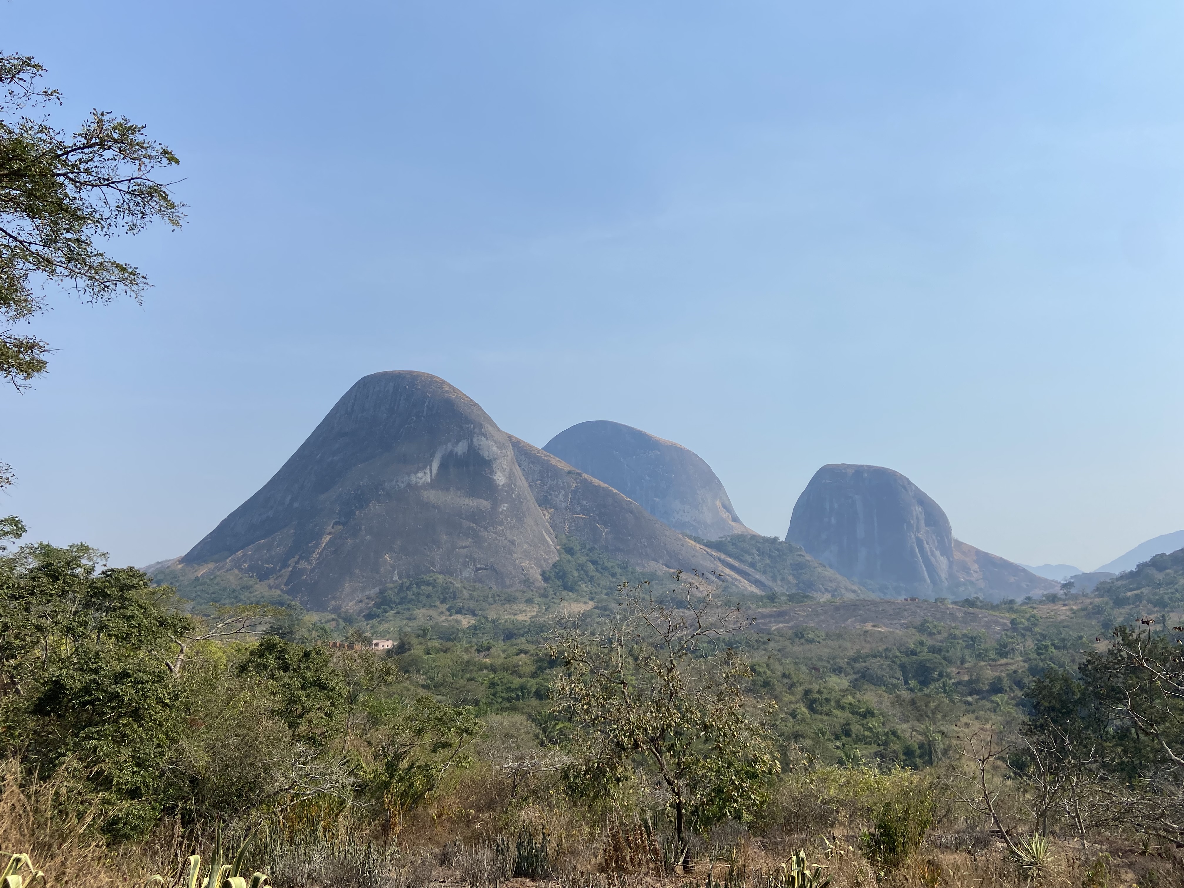 Three large granite domes erupting out from the jungle below.