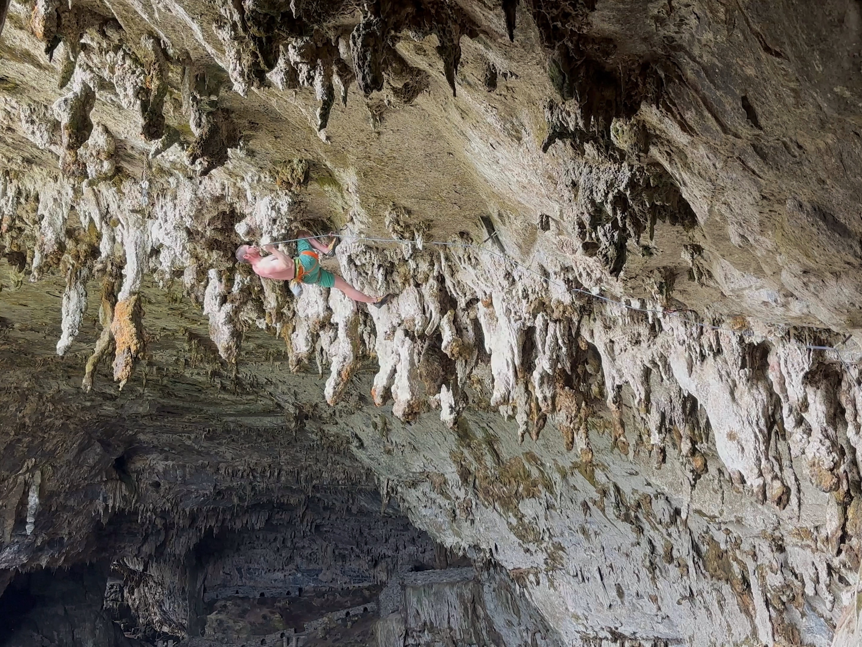Climber on horizontal climb among the giant tufas in the limestone cave.  