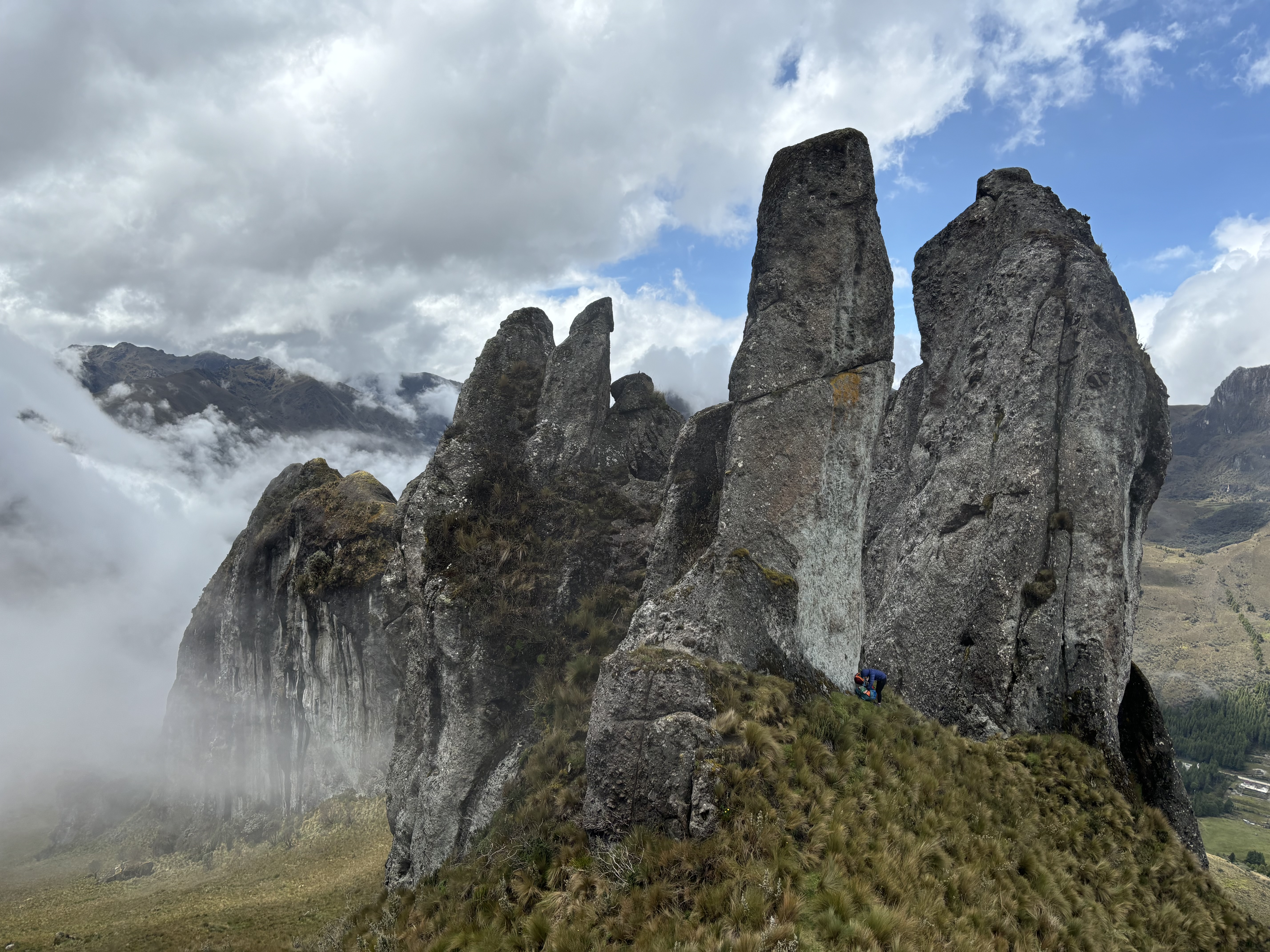Rocky pillars and features set high upon grassy mountains. 