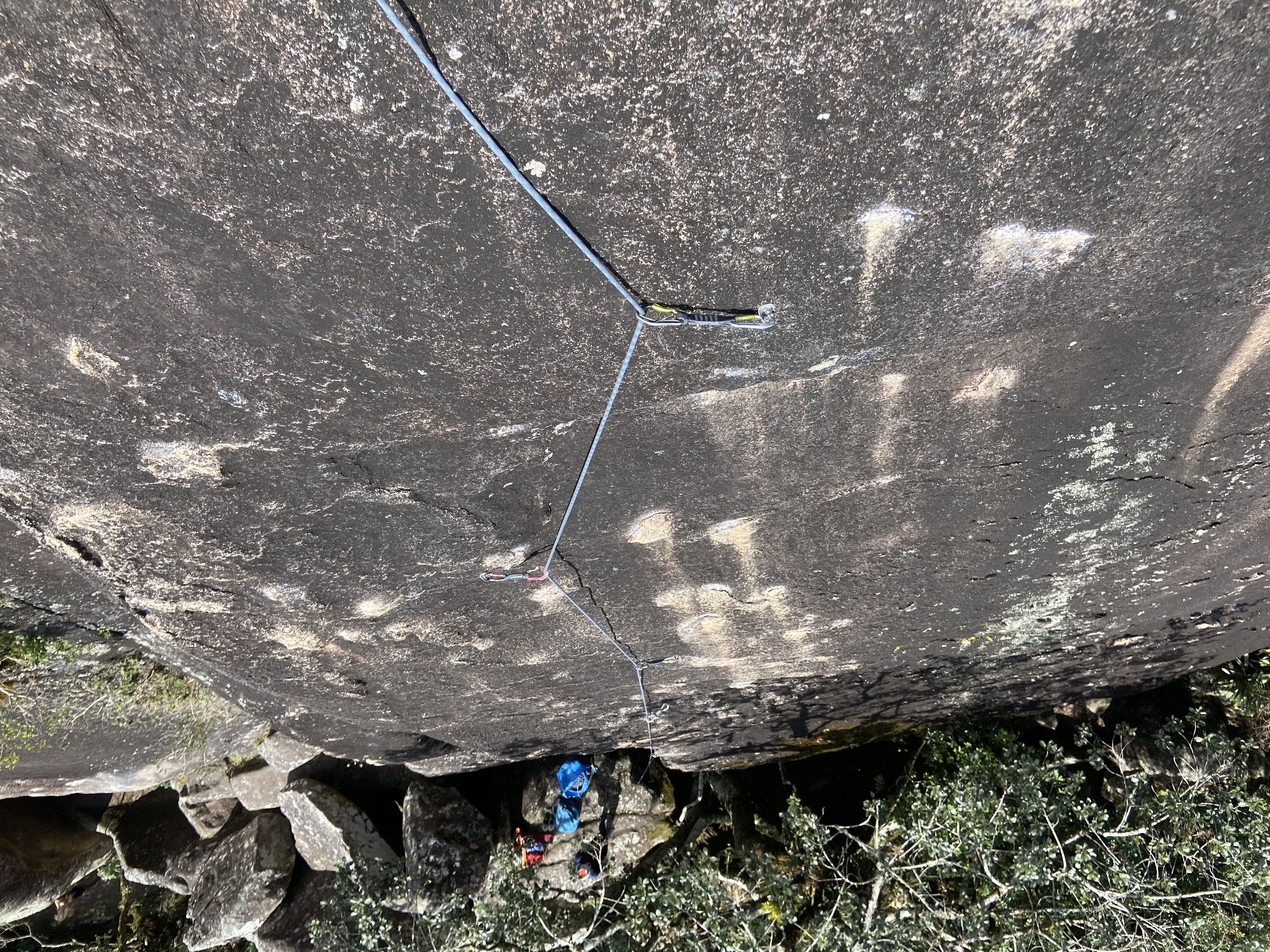 Grey volcanic slab of rock covered in small, light coloured crimps.
