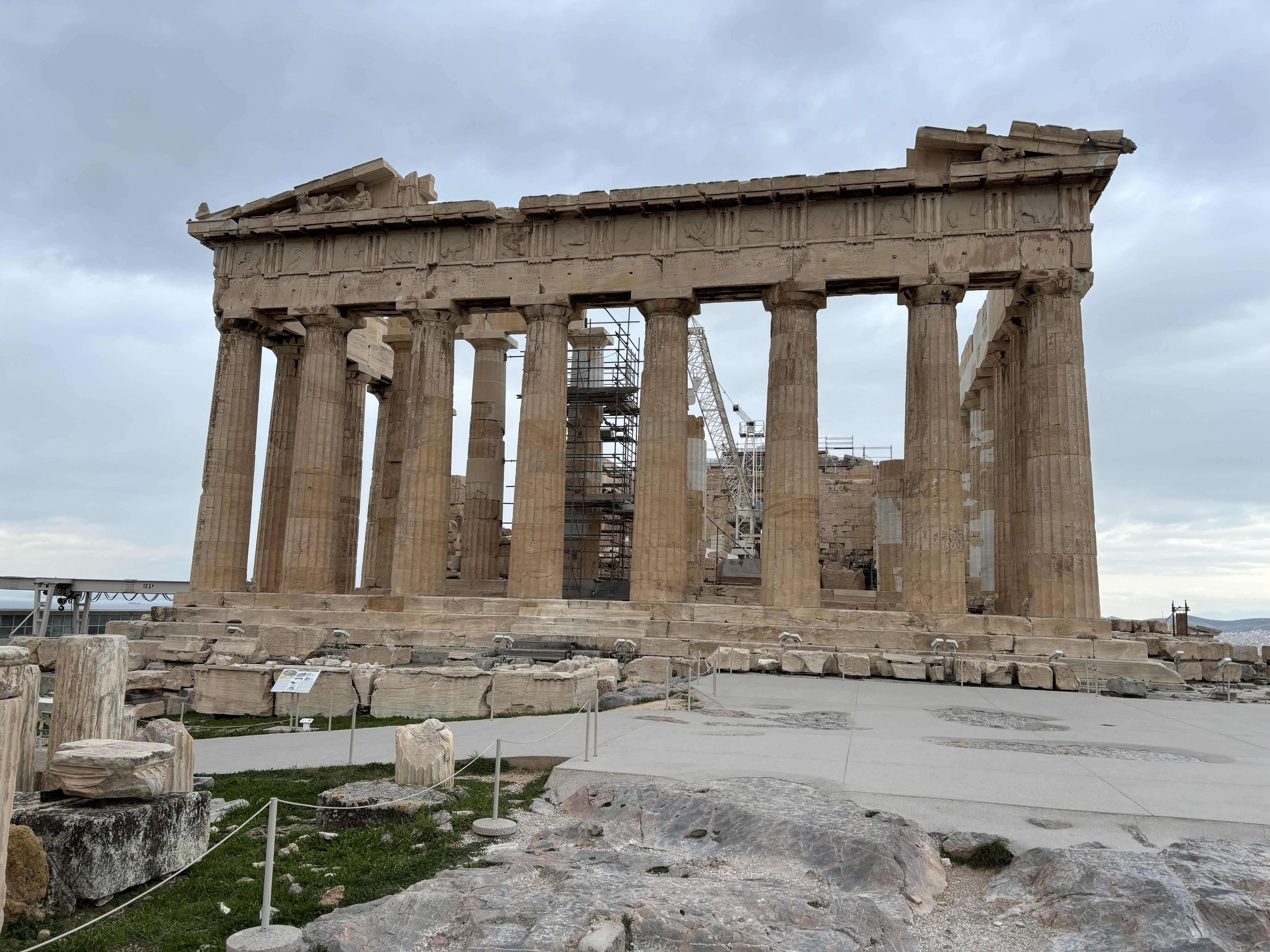 A view of the Parthenon, an ancient Greek ruin with large, stone columns.